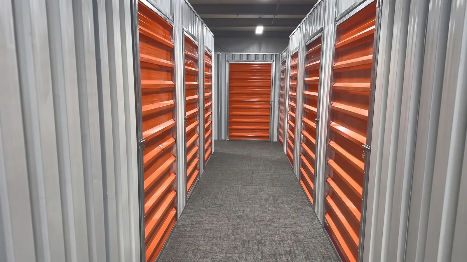 Corridor of orange storage doors at a Green Sky storage site